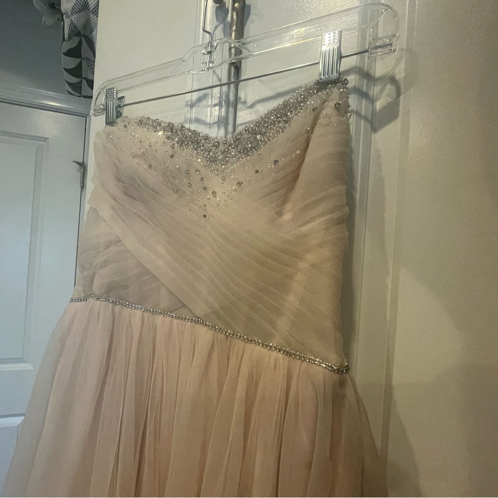 Brand new with tags, wedding dress, size 12. Gorgeous blush color with sparkle.